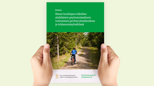  Hands are holding the handbook, which has a child with a bike on the cover. 